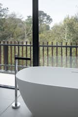 Bath Room, Ceramic Tile Floor, Stone Counter, Freestanding Tub, Stone Slab Wall, and Open Shower  Photos from Warraweena