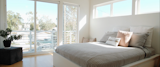 Bedroom, Light Hardwood Floor, and Bed Eastern upper windows in the master suite capture the sunrise and fill the room with indirect light create a refreshing wake up experience.  Photo 9 of 11 in English House by Johndavid Carling