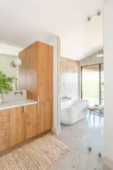 Neutral tones continue into the master bath to create a spa feel.  Terrazzo patterned floor tile adds some interest; pale zellige tile in the wet bath adds just a hint of color. 