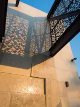 A detail of a water feature and screen intersecting,