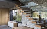 Staircase, Glass Railing, and Wood Tread The staircase cantilevers out of the stoneclad wall  Photo 11 of 48 in Modern farmhouse Blair Atholl by Nico van der Meulen
