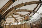 Exterior Organic bamboo columns support the light covering  Photo 7 of 24 in Bamboo Flower _Restroom pavillion by Manu Ponte