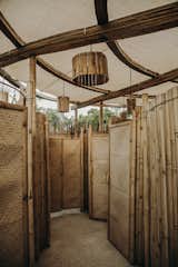 All the walls and doors are also formed with bamboo, reed and fibers to create a monocromatic but textured appearance.   Photo 14 of 24 in Bamboo Flower _Restroom pavillion by Manu Ponte