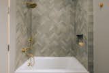 Bathrooms feature Kohler fixtures and hardware and fireclay tile