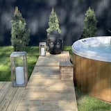 Backyard with modern, cedar hot tub and cedar deck. 