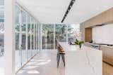 Center stage in the designer kitchen is a 20’ center island wrapped in quartz. Designer modern lighting elements add flair – an unexpected 21’ wall of folding glass doors open to reveal a terrace.
