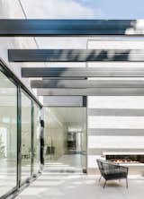 A large back terrace shows off a double-sided fireplace and custom steel beams. Twenty-one feet of folding glass doors allow for a deep indoor-outdoor connection.