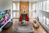 Living room with a custom teak wall to hight light the new black marble fireplace surrounded by paolo buffa 1950 chairs in teak, costumed art by his own brother and a lot of midcentury modern furnishings 