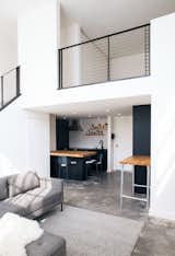 Metal railing with acid-washed finish by Mission Iron Works in Hunter's Point, San Francisco. 'Paramount' couch & ottoman from Blu Dot.