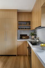 The kitchen millwork is made from custom rift white cut oak with CaeserStone Naked Concrete countertops and backsplash.