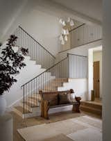 Honey-hued wood and deep walnut accents warm up this simple entryway.