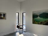 Master bedroom with antique nightstand and photograph of Laguna Guatavia in Sesquilé, Colombia