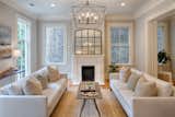 Living Room, Pendant Lighting, Ceiling Lighting, Light Hardwood Floor, Recessed Lighting, and Standard Layout Fireplace  Photo 3 of 39 in Newly Renovated Historic Home in Savannah GA by Historic Savannah Homes By Liza DiMarco