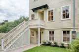 Outdoor, Vertical Fences, Wall, Grass, Back Yard, Shrubs, Small Patio, Porch, Deck, Hardscapes, Concrete Fences, Wall, and Walkways Back View of Home  Photo 16 of 17 in Liberty Manor by Historic Savannah Homes By Liza DiMarco