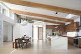 An urban loft aesthetic with a high-ceiling central space with natural light.