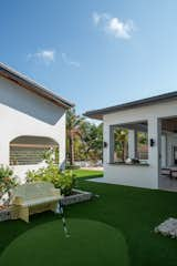 back portion with mini putting green between residence and boat house. 