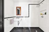 The new black-and-white bathroom has a vintage feel. Wall tiles are an elongated variation of traditional subway tiles. 