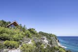 Perched high on a cliff, MU50 overlooks a stunning landscape of pinewoods and the Aegean Sea.