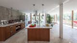 Kitchen, Undermount Sink, Marble Counter, Wood Cabinet, Ceiling Lighting, Refrigerator, Cooktops, Concrete Backsplashe, Travertine Floor, and Dishwasher Kitchen  Photo 14 of 15 in T-House by Teke Architects Office