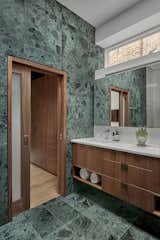 Main bathroom with custom millwork and marble tile