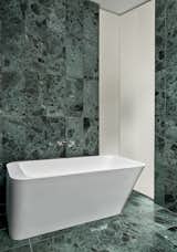 Main bathroom with free-standing tub and marble tile