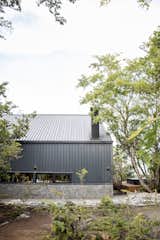 Exterior, A-Frame RoofLine, Shed Building Type, Farmhouse Building Type, Barn Building Type, Stone Siding Material, House Building Type, and Metal Roof Material South facade covered with opaque metal blanklet.  Photo 2 of 11 in Casa La Puntilla by Cristóbal Pérez