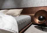 Low, wood cot in the bedroom