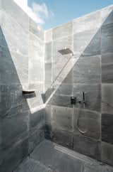 Open-to-sky shower clad in Indian slate stone in a scaled, natural finish 