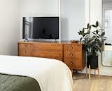 Interior shot of a renovated bedroom witih wooden media console.