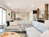In the main entertaining area is a Living Room adjacent to the kitchen and dining room. Here you will find a comfy sofa, coffee table, board games, and a 65” Smart TV, perfect for family and friends to gather around and relax.
