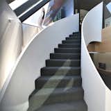 Our studio explored the residual and vertical spaces of the stairs. Here they sweep around a driftwood sculpture which can be enjoyed from multiple perspectives.