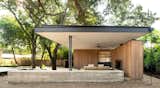 Outdoor, Concrete Patio, Porch, Deck, Horizontal Fences, Wall, Trees, Concrete Fences, Wall, Large Patio, Porch, Deck, and Back Yard Pavilion floating roof   Photo 2 of 6 in Austin Pool Pavilion by Hunt Architecture
