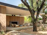 Outdoor, Large Patio, Porch, Deck, Back Yard, Concrete Fences, Wall, Horizontal Fences, Wall, Concrete Patio, Porch, Deck, Trees, Wood Patio, Porch, Deck, Walkways, and Decking Patio, Porch, Deck Pavilion between the oaks  Photo 4 of 6 in Austin Pool Pavilion by Hunt Architecture