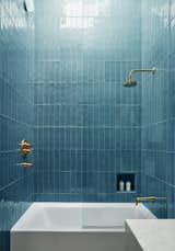 Guest bathroom with full height tile and skylight