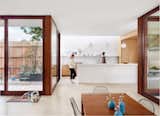 Dining room with view to kitchen.  Access to Entry Courtyard on left and to Patio and Pool on right
