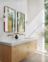 Primary bathroom vanity and entry to walk-in shower