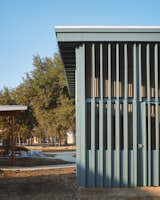 Exterior, House Building Type, Wood Siding Material, Stucco Siding Material, Metal Siding Material, Metal Roof Material, Tiny Home Building Type, and Shed RoofLine Painted wood screened porch  Photo 7 of 13 in Tiny Victories 2.0- 260sf dwelling by Jamie Chioco