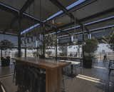 Dining Room, Floor Lighting, Stools, Medium Hardwood Floor, Chair, Bar, Bench, Ceiling Lighting, and Table  Photo 14 of 14 in Rooftop Falabella Lira Tuckermann by Pablo Casals Aguirre