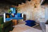 Living, Sofa, Console Tables, Ottomans, Wood Burning, and Limestone The designers decided to keep the original stone walls and floors.  Living Sofa Ottomans Console Tables Photos from Design apartments in Italian ghost towns