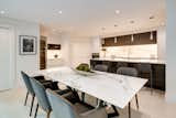 Dining room and kitchen with backlit Quartzite backsplash.