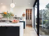 A massive hidden pantry behind the kitchen (the owner’s favorite room in the house) hides many appliances, ample storage, plenty of workspace, and a 146-bottle wine fridge.