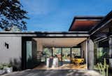 What's repeated constantly throughout is the connection between the outdoors and in: as seen here in the kitchen that opens completely to the backyard and also in the two-story atrium that connects the two levels of the  house.