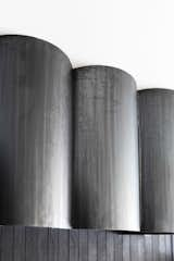 Blackened steel was formed into tubular shapes for the custom range hood cover