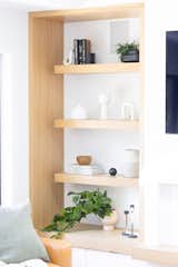 Open shelves in the living room offer opportunities to showcase some sculptural accessories and add some greenery