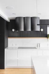 Blackened steel was formed into tubular shapes for the custom range hood cover