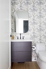 In the powder room, a beautiful Harewood Avington wallpaper—courtesy of Maxwell Fabrics—is instantly chic and whimsical, yet feels classic and timeless.