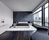 MASTER BEDROOM - B&B Italia King size bed; Poliform chest of drawers and TV unit; large custom mirror designed by Giusi Mastro; Ingo Maurer fixture.  Photo 8 of 8 in SoHo Loft by ORA Studio NYC by Giusi Mastro