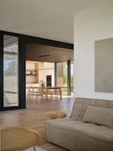 Dining Room, Pendant Lighting, Chair, Light Hardwood Floor, and Table View to Dining Room and Kitchen from Living Room  Photo 9 of 14 in Dubhouse by everyday studio