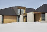 Exterior, Brick Siding Material, House Building Type, Wood Siding Material, Flat RoofLine, Metal Roof Material, and Hipped RoofLine Front Approach  Photo 12 of 14 in Dubhouse by everyday studio