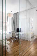 Now, a glass box in the corner defines the living space and allows light to flow through. The glass walls enable transparency, but can also foster privacy when needed. Blair has used the space as an office, and when surrounded in curtains, a kid’s room.